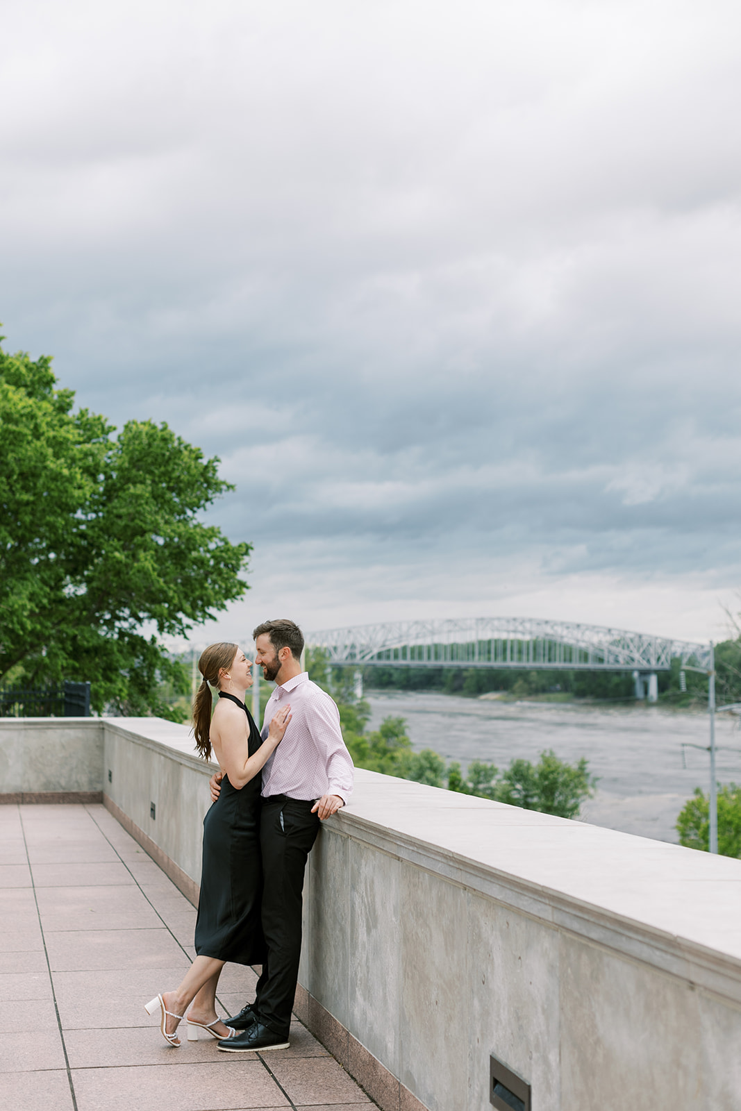 A couple standing near the Missouri Capital for their spring engagement session in Jefferson City, Missouri. The session captured by Kiley Ann Photography was a classic theme with black and white outfits and neutral backgrounds.