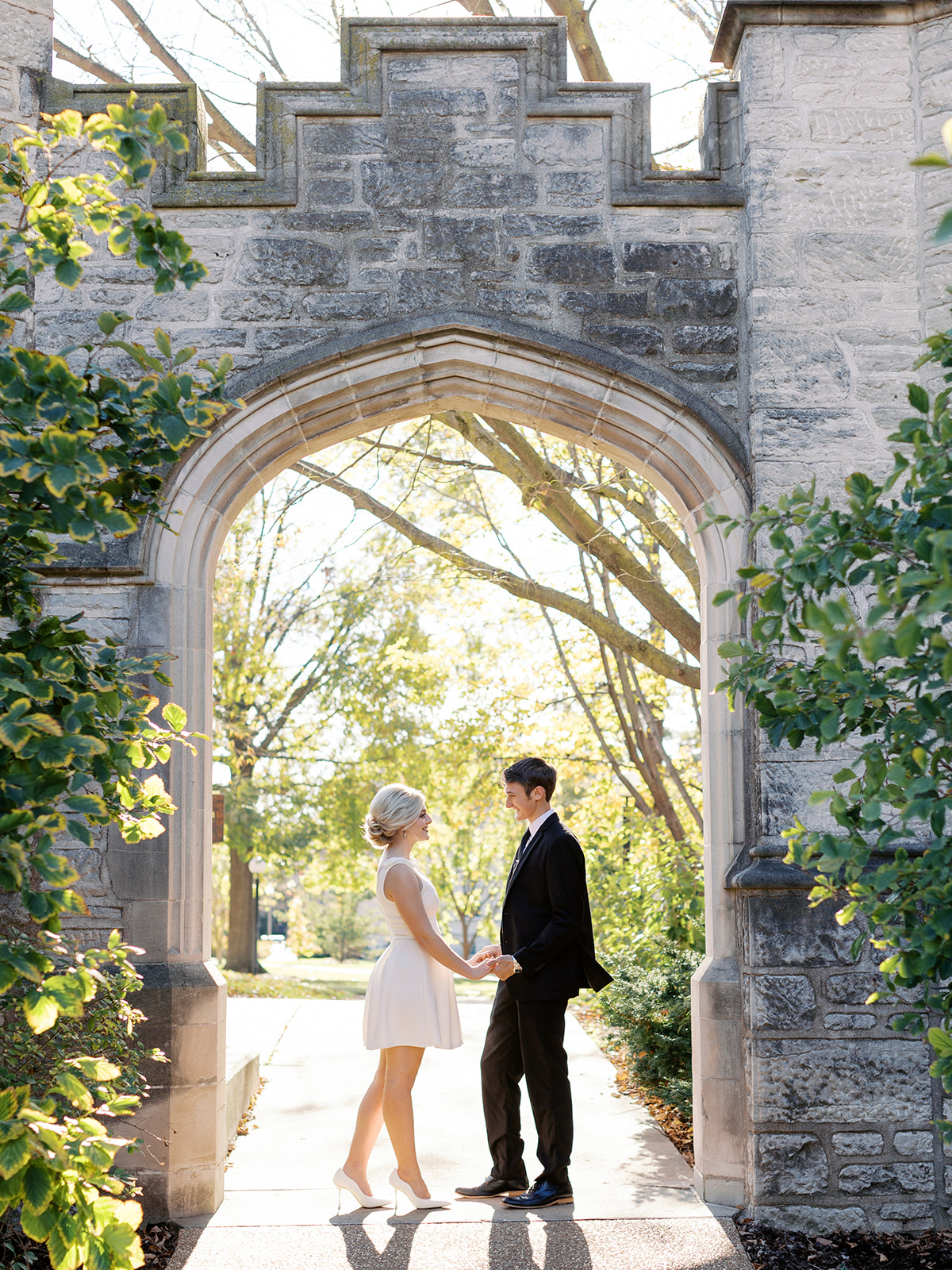 A couple standing at the University of Missouri posing for their engagement session with Columbia Missouri wedding and portrait photographer Kiley Ann Photography