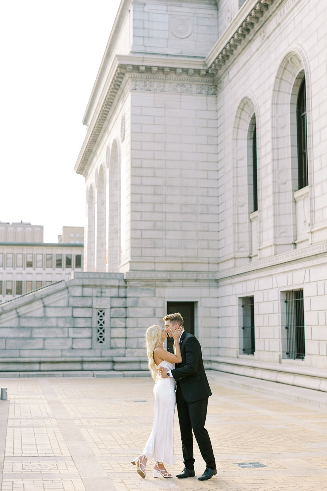 A couple about to kiss with the evening sunlight shining on them during their sunset engagement session in St. Louis, Missouri.