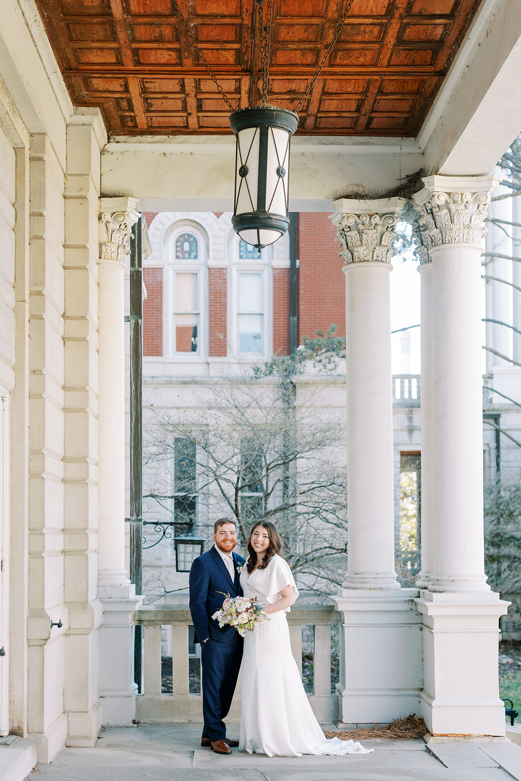 A couple posing on their wedding day at the University of Missouri during their husband and wife portraits with Kiley Ann Photography in Columbia, Missouri.