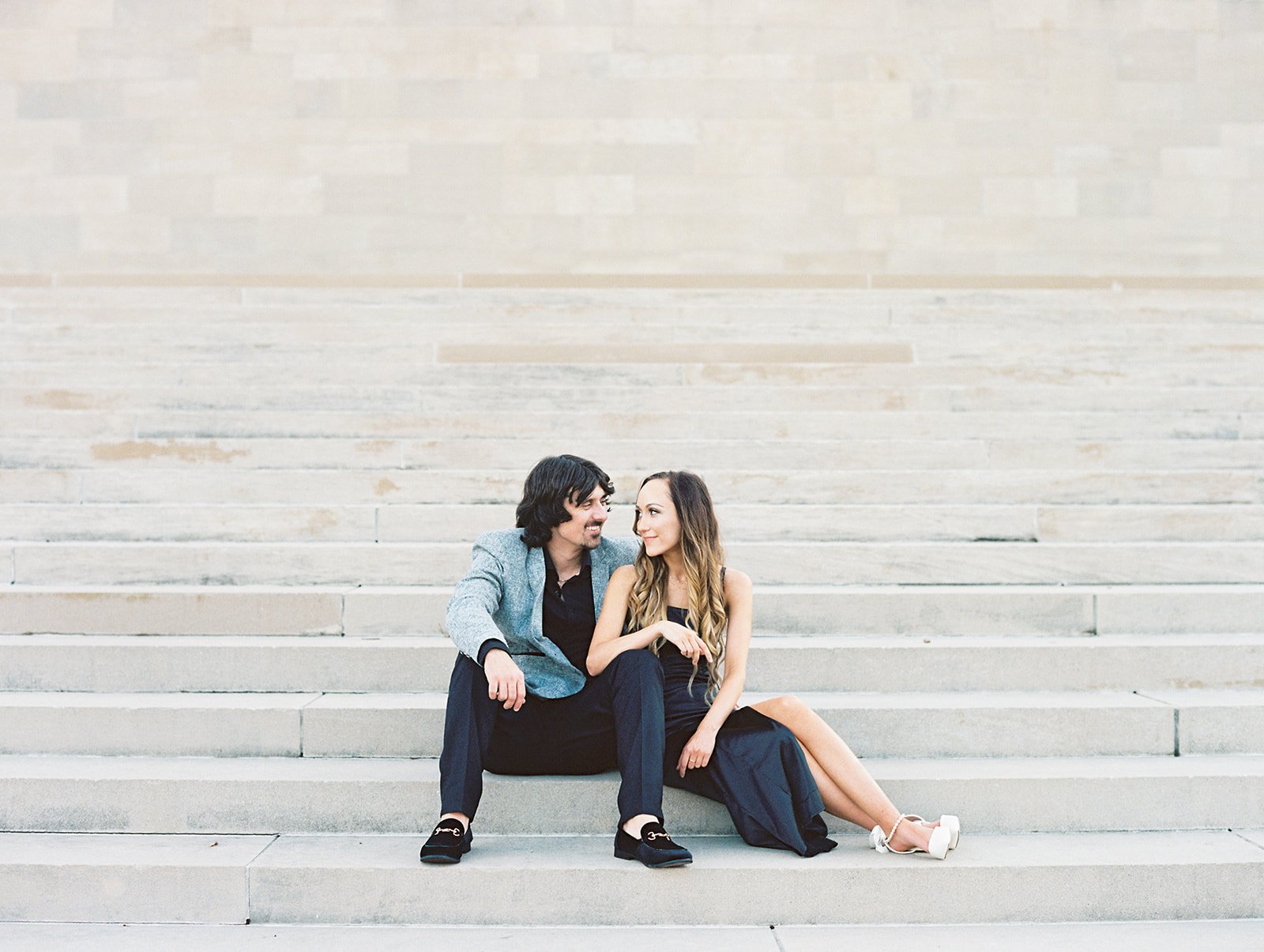 A couple posing at the National WWI Museum and Memorial for their engagement session in Downtown Kansas City Missouri
