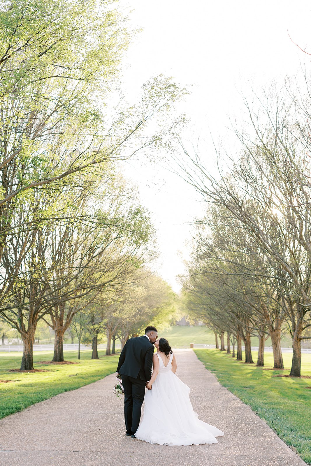 A couple in the driveway of the Callaway Jewel kissing during sunset in Fulton, Missouri.