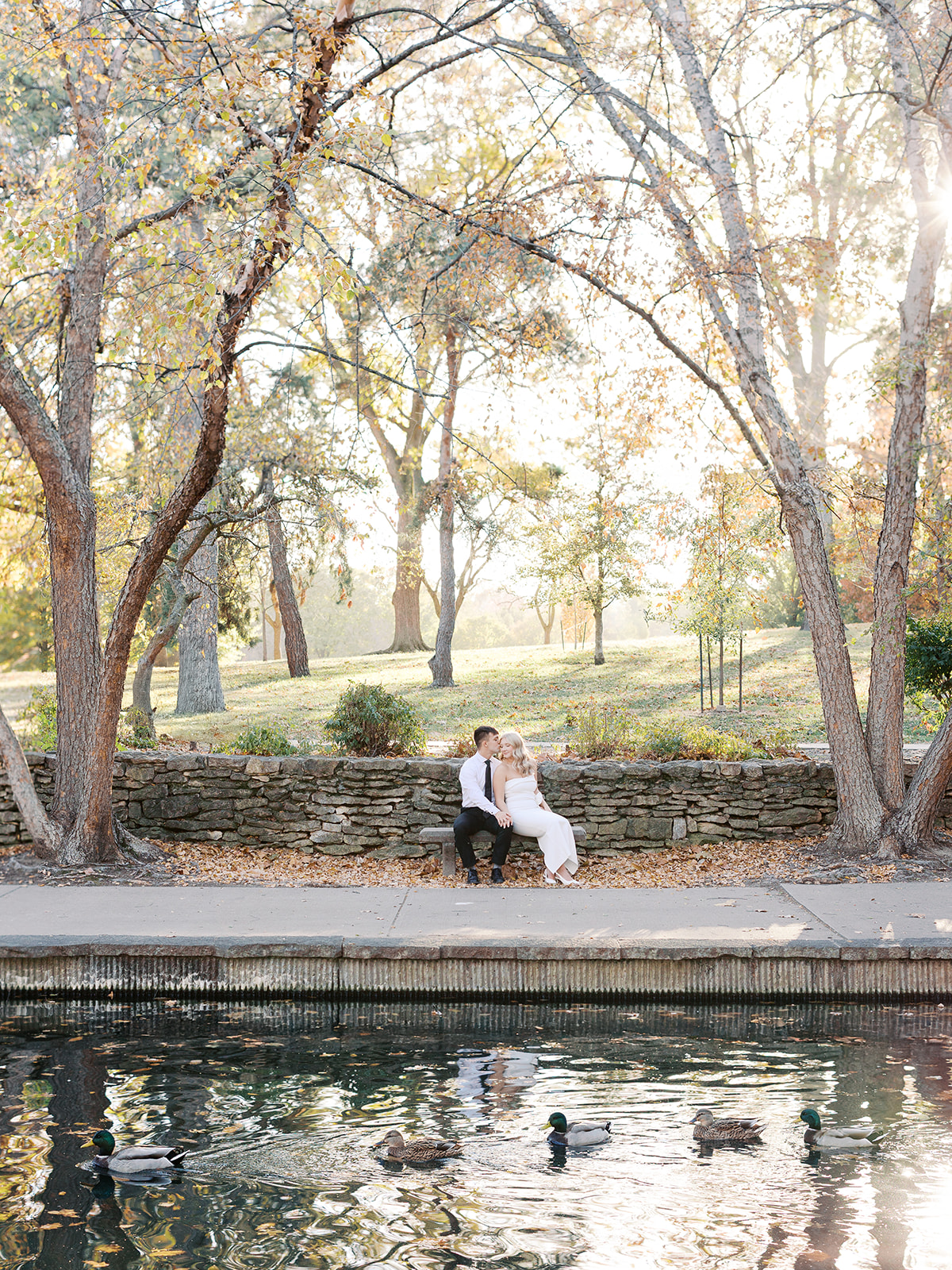 A couple sitting at Loose Park in Kansas city for their timeless engagement session with Kansas City wedding photographer, Kiley Ann Photography.